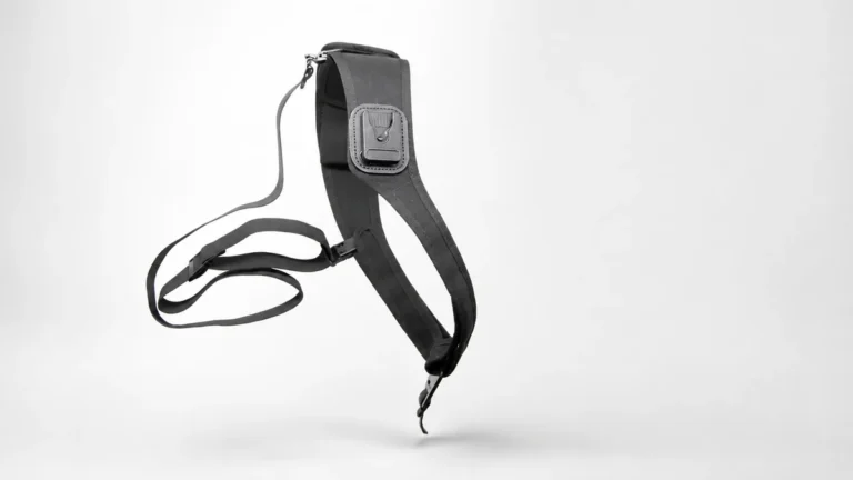 Body camera shoulder harness with a padded strap, camera dock and lanyard