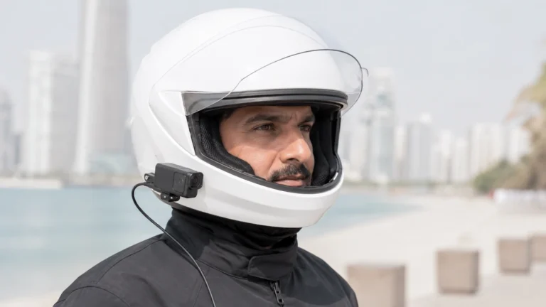 Rider with a body camera mounted on a white full face motorcycle helmet