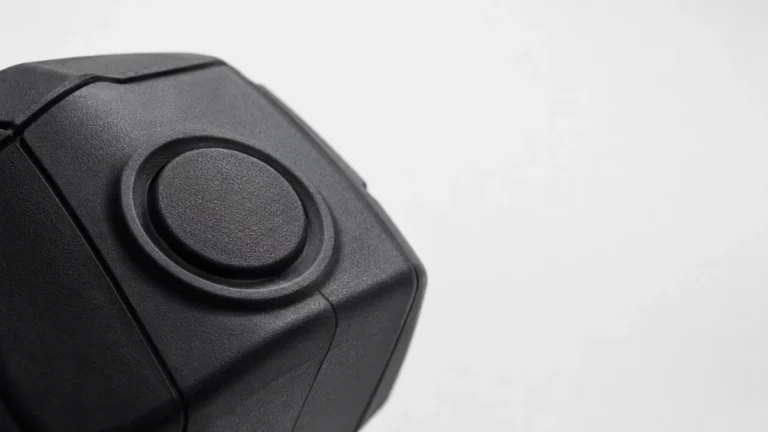 Close-up of the large round record button on the front of a body camera