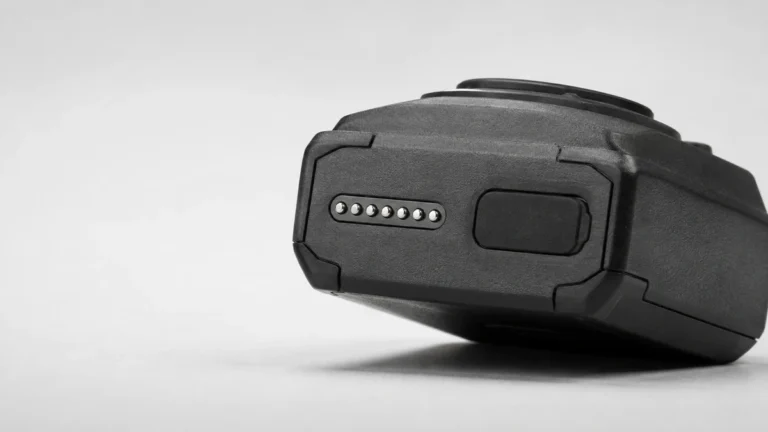 Underside of a body camera showing its sealed charging contacts