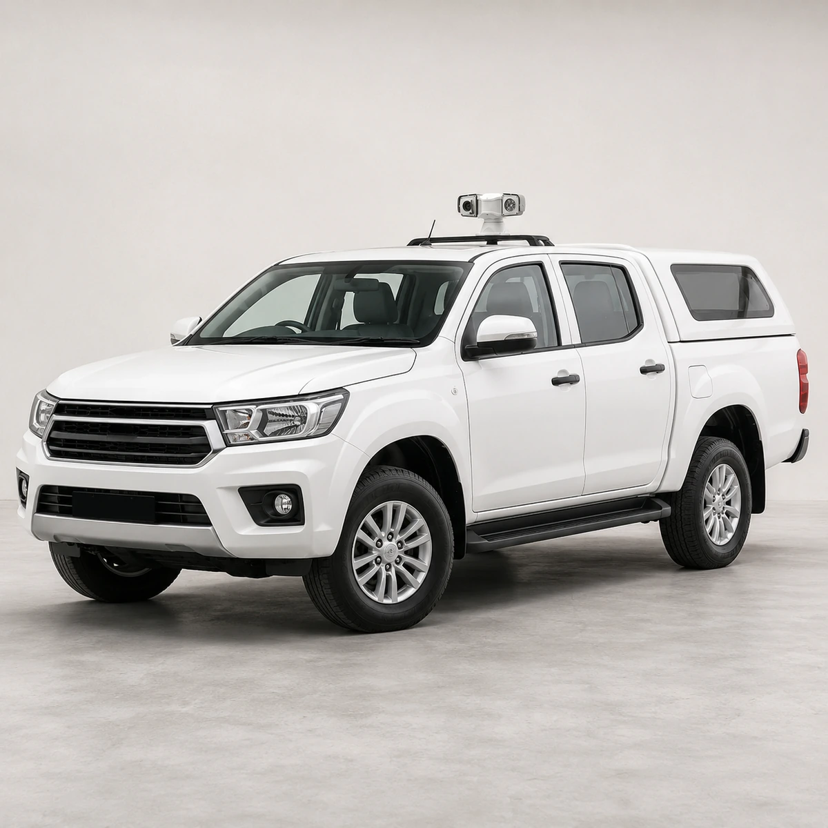Vehicle PTZ camera mounted on the roof bar of a white double cab pickup, showing how the head sits above the cab with a clear line of sight all round